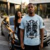 BLACK ICE HOCKEY EST. 1885 tee – man wearing the graphic shirt near a Mercedes-Benz